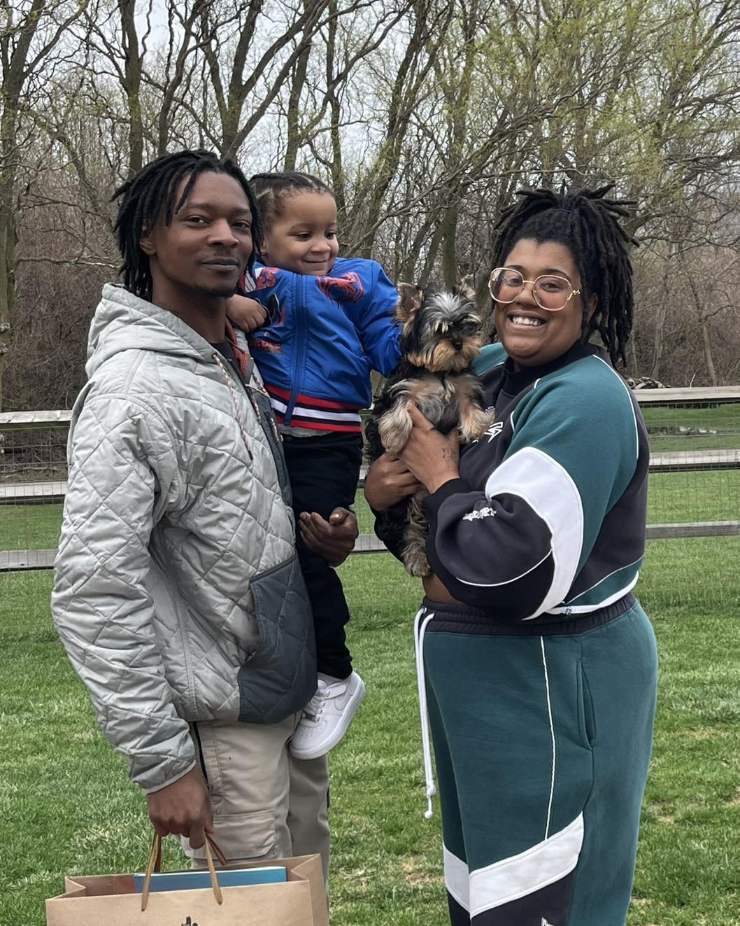 Happy family with their Yorkie puppy